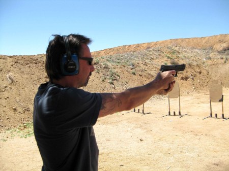 Dane shooting the bad guy targets ( the ones with guns ).